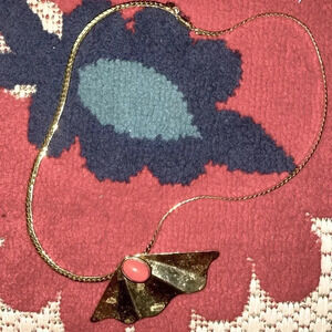 Vintage gold tone fan with coral lucite stone signed CCA​​​​